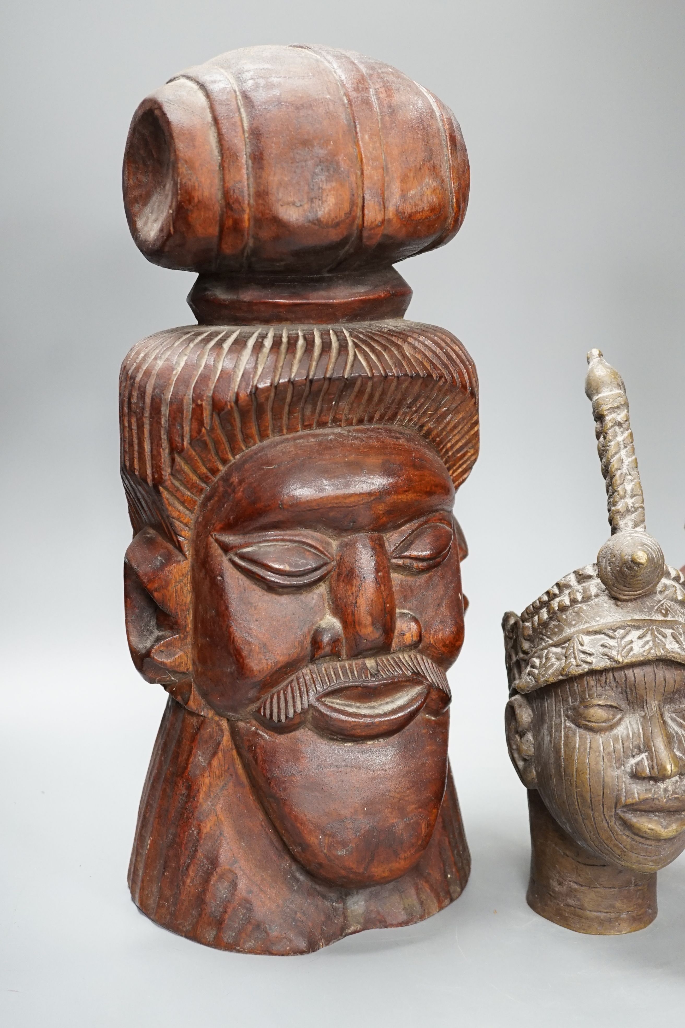 A metal Benin style bust, a carved tribal bust and another